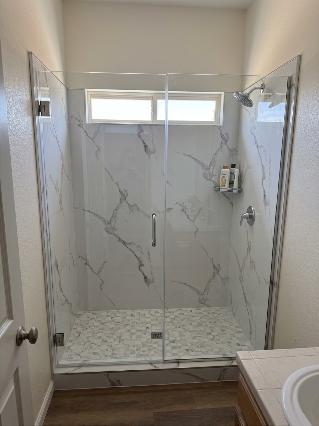 Finished walk-in shower with Pianello XL panels and frameless glass